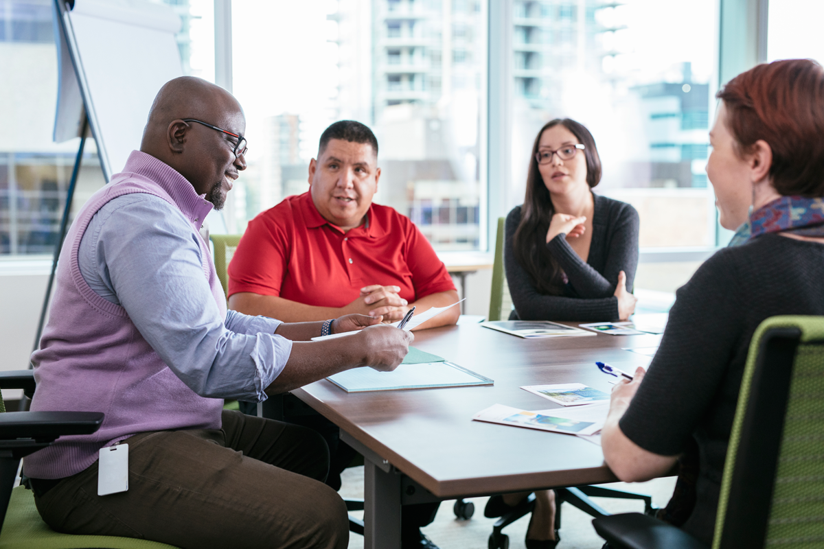 Four people having a discussion at a table