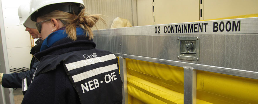Inspectors inside an Oil Spill Containment and Response trailer