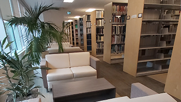 Rows of books on shelves of our library. Shows one way we give everyone access information.