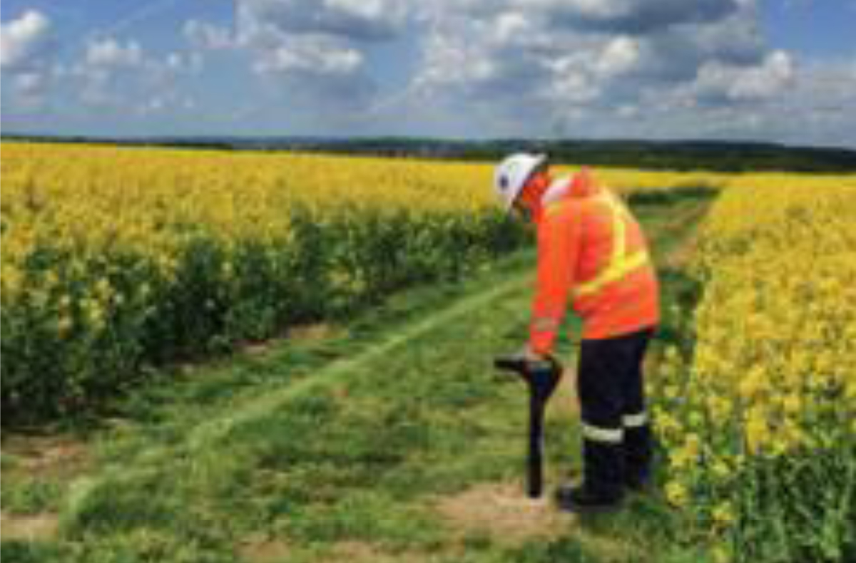 Figure 14 – Company representative locating the pipe and checking for depth.