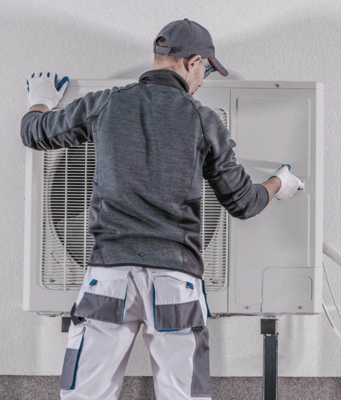 Worker installs heat pump.
