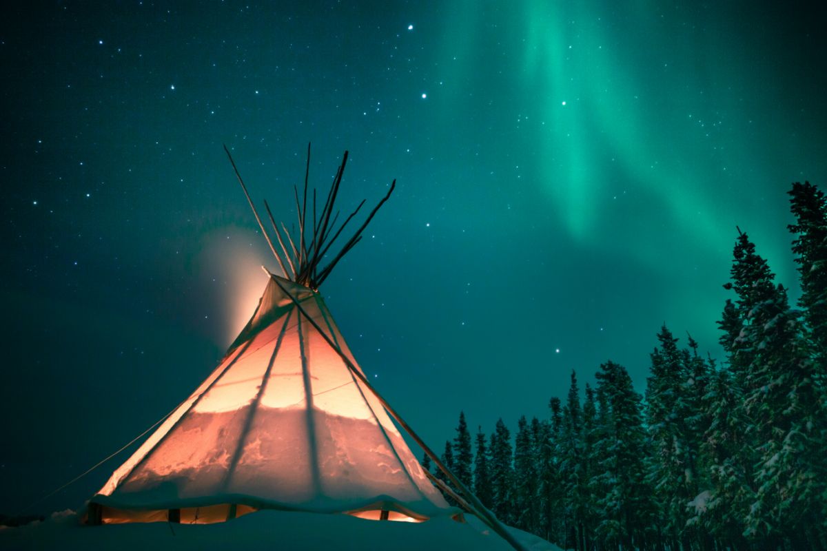 Teepee under starry sky.