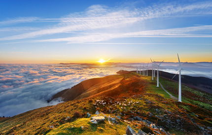 Coastal wind turbines at sunset