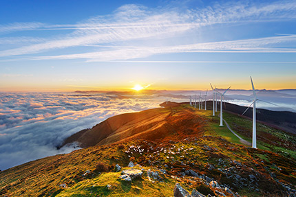 Coastal wind turbines at sunset.