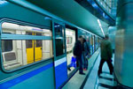 Passengers stepping out of a subway car