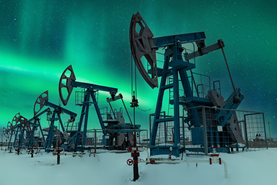 Oil field pump jacks with northern lights