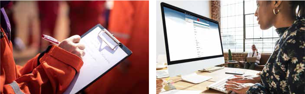 Close up of someone in PPE writing on a clipboard.