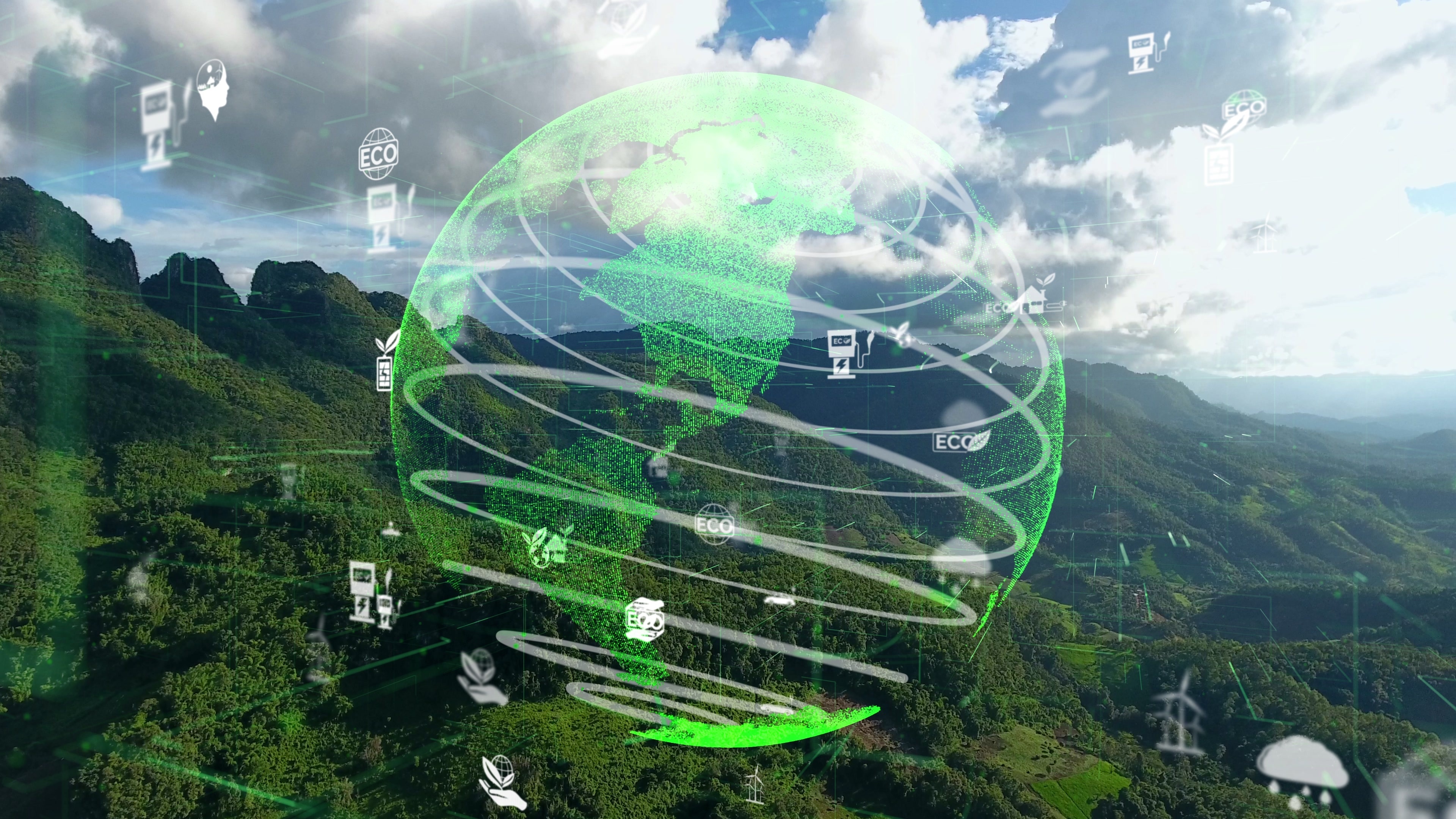 Un globe terrestre transparent et de petits symboles représentant l’énergie renouvelable se superposent à une image de paysage verdoyant.